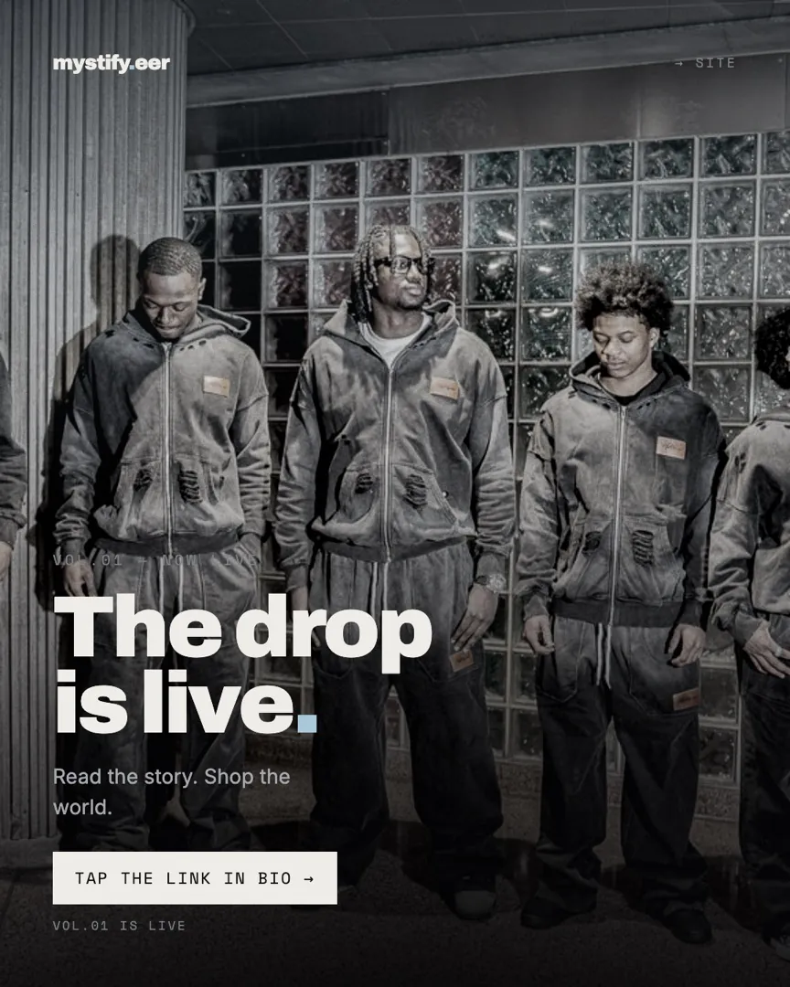 Four models in matching washed-black mystify.eer hoodies and trousers against a glass-block wall, captioned The drop is live
