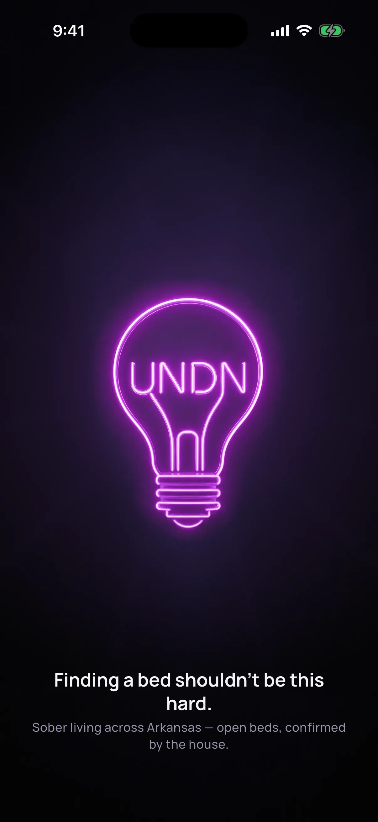UNDN app splash: the neon lightbulb above Finding a bed shouldn't be this hard.